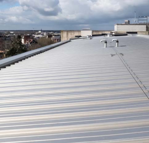 Durable metal roofing solution being installed on a modern commercial building in sacramento ca