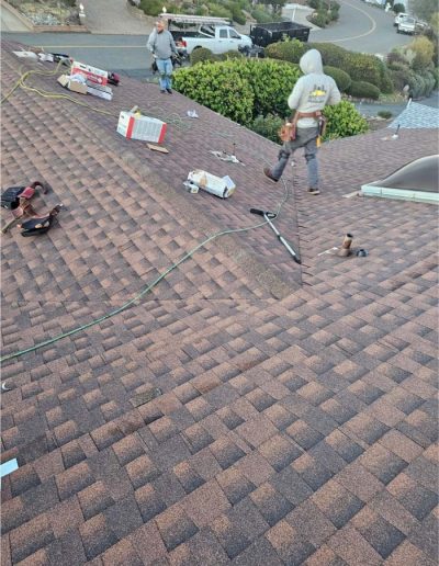 Professional shingle roofer installing asphalt shingles on a residential home in solano County