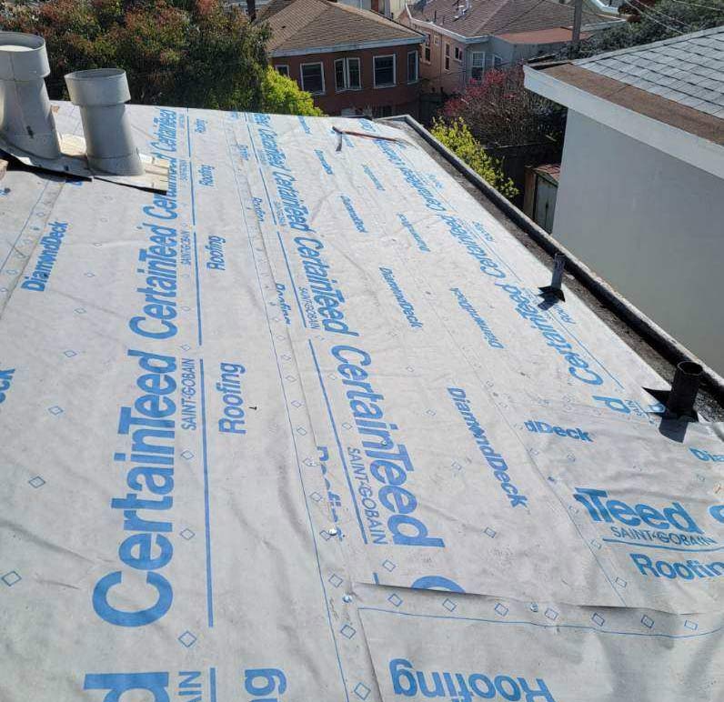 Drone view of a large residential property showcasing a TPO roof in rancho cordova in progress by roof city inc